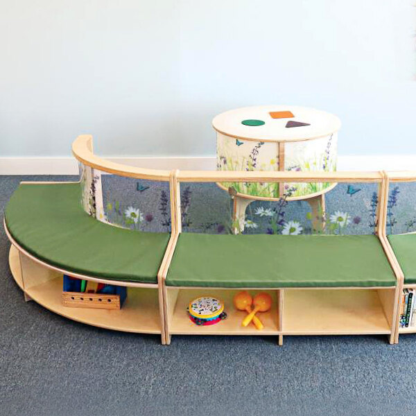 A green cushioned Whitney Brothers wood curve-in bench with toys and a drum on it.