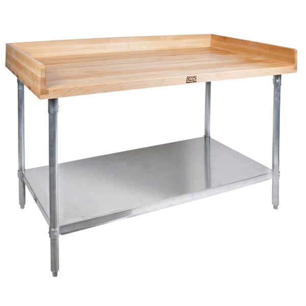 A John Boos wood top baker's table with stainless steel legs and shelf.