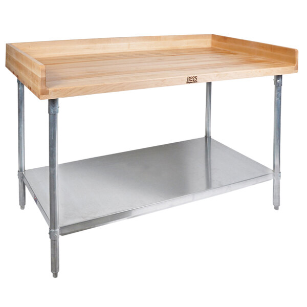 A John Boos wood top baker's table with a galvanized metal base and adjustable shelf.