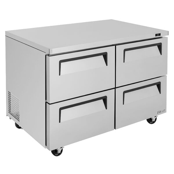 A white Turbo Air undercounter refrigerator with four drawers.