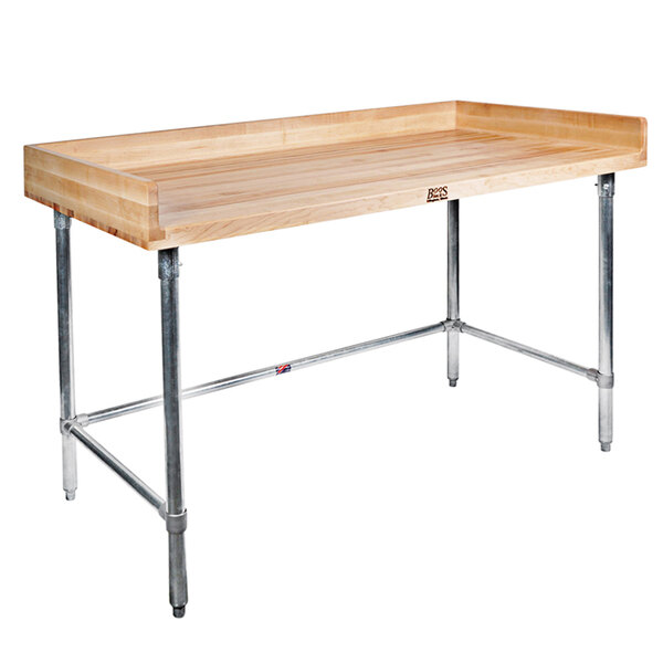 A John Boos wood top work table with a stainless steel base and shelf.