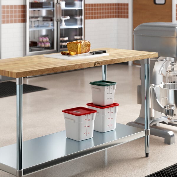 A John Boos wood top work table with food on it.