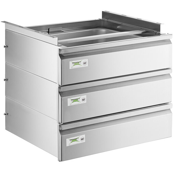 A Regency stainless steel triple-stacked drawer set on a metal counter with white labels on the drawers.