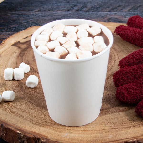 A Dart double wall insulated white paper hot cup filled with hot chocolate and marshmallows.