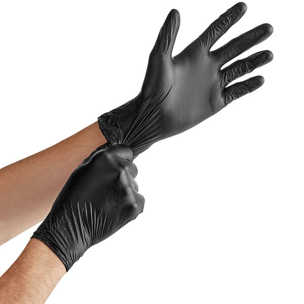 a person putting on black gloves