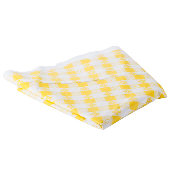 A folded yellow and white checkered vinyl table cover.