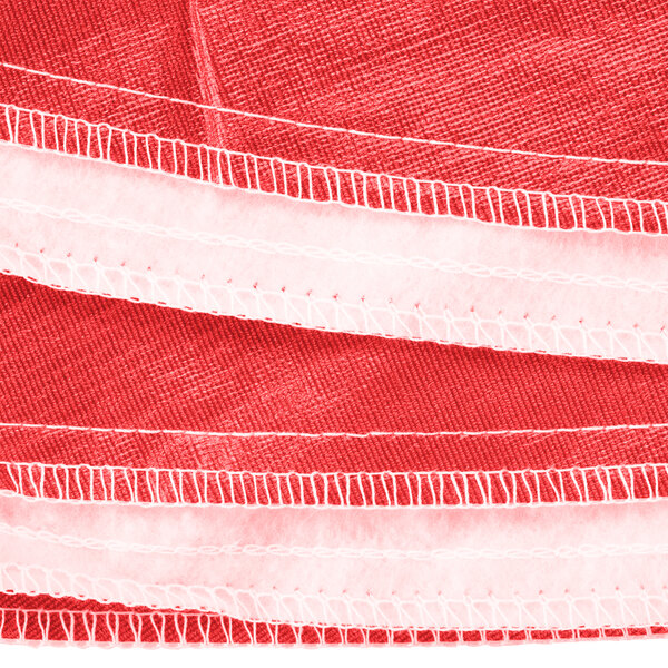 A close up of a red vinyl table cover with flannel back.