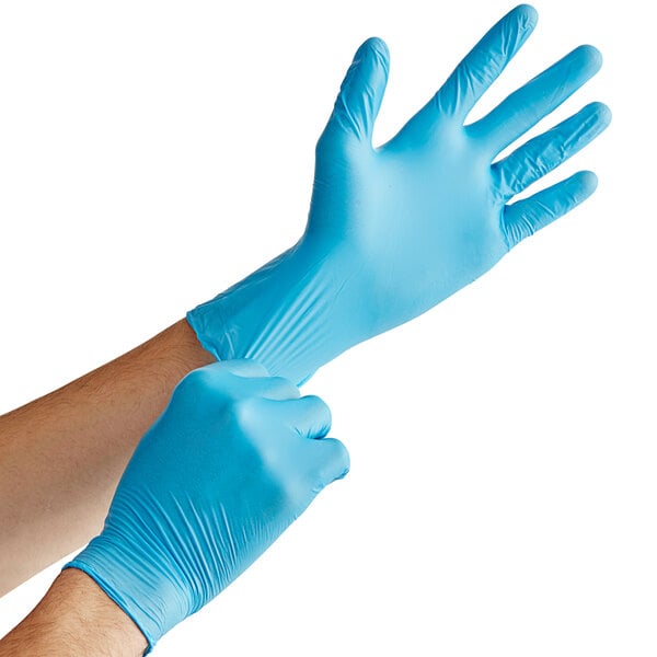 a person putting on blue gloves