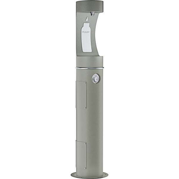 An Elkay grey rectangular outdoor water fountain with a round white cover.