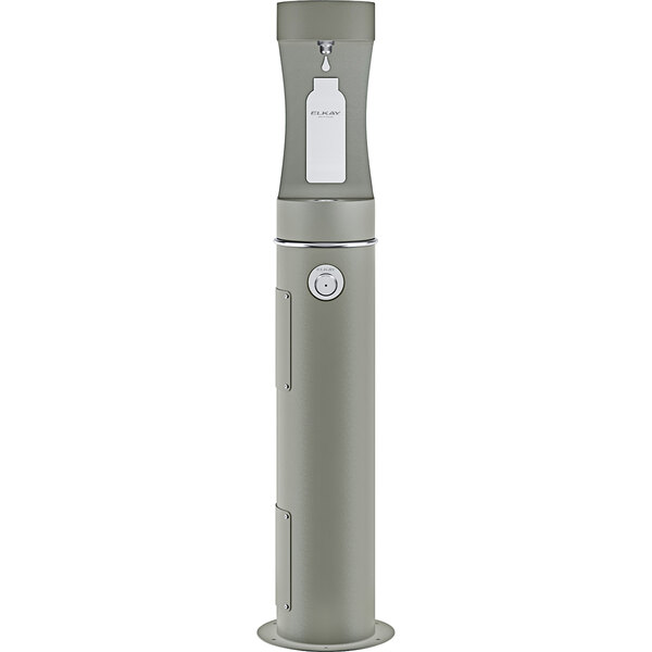 An Elkay grey rectangular outdoor water fountain with a round button and a white label over a water bottle with a small handle.