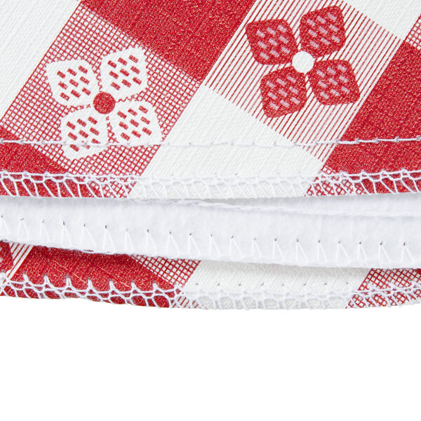 A red and white checkered vinyl table cover with a flannel back.