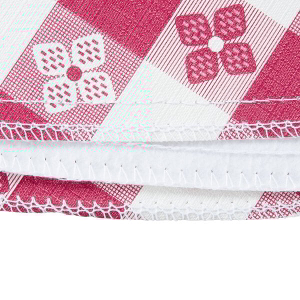 A close-up of a red and white gingham vinyl table cover with a flannel back.
