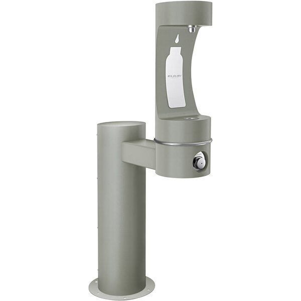 An Elkay grey metal pedestal bottle filling station with a white cylinder and black top.