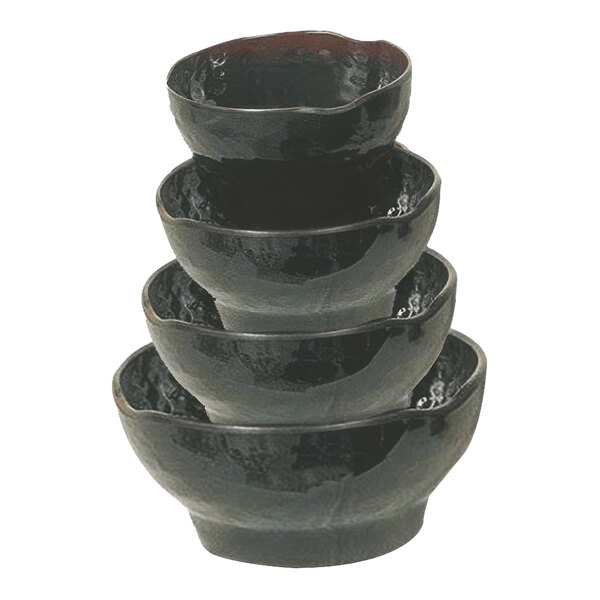 A close-up of a stack of Thunder Group Tenmoku Black Melamine Rice Bowls.