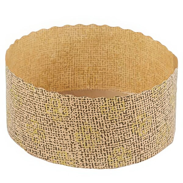 A round brown paper baking mold with a gold pattern.