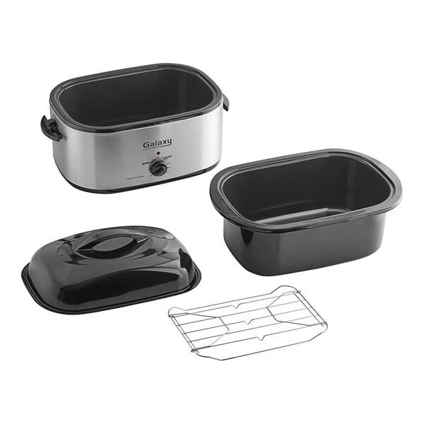 A black and silver Galaxy countertop roaster oven with a lid on a tray on a kitchen counter.