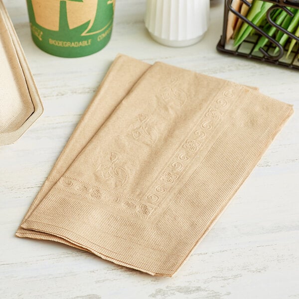 a pair of beige napkins on a white surface