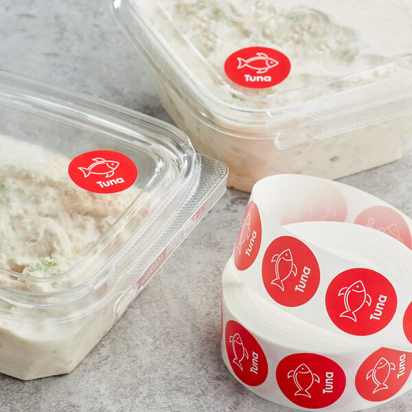 A roll of red and white Point Plus Tuna Permanent labels.