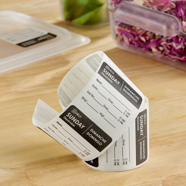 A roll of 2-inch by 2-inch dissolvable Sunday day of the week labels for food storage.