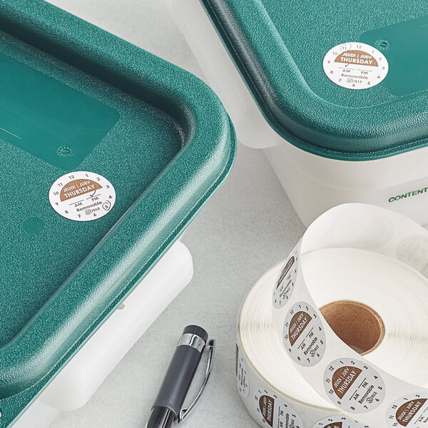 A roll of Noble Products Thursday day of the week stickers on a green plastic container.