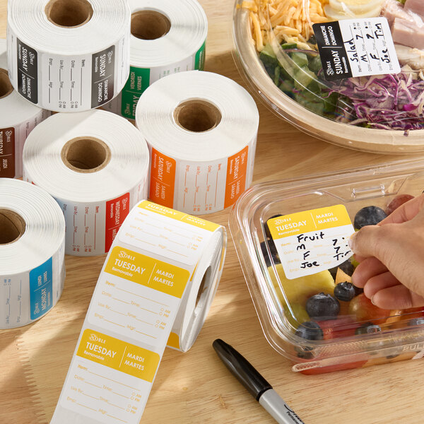 A set of removable day of the week label rolls used for food storage and organization.