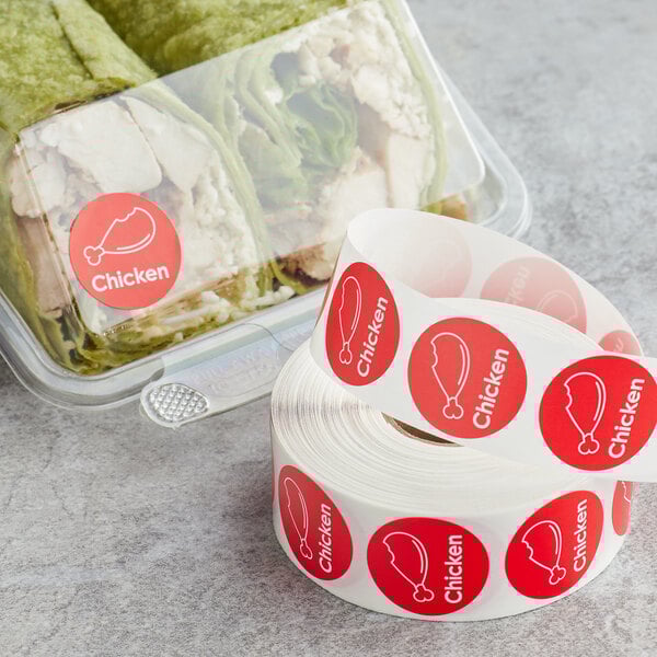 A roll of Point Plus chicken labeling stickers with a red label on a roll.