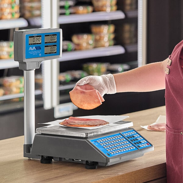 A person weighing meat on an AvaWeigh digital price computing scale with a tower.