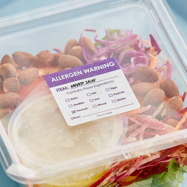 A plastic container of salad with a Noble Products allergen label on it.