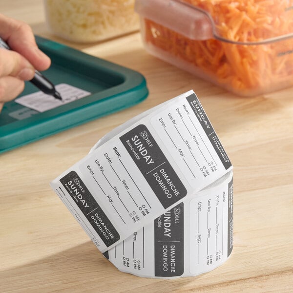 A roll of removable day of the week labels marked for Sunday, used for food storage and organization.