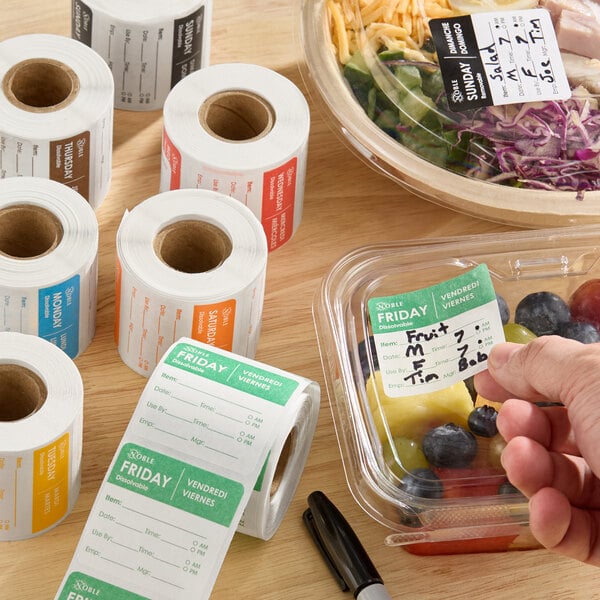 A set of Noble 2-inch by 2-inch dissolvable day of the week label rolls used for food storage and organization.