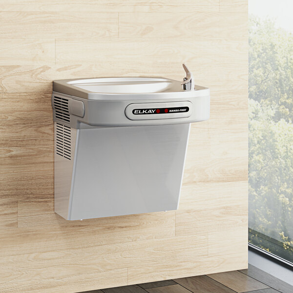 An Elkay stainless steel wall mounted chilled drinking fountain with a faucet.