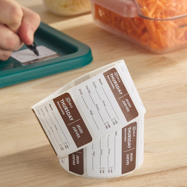 A roll of removable day of the week labels marked for Thursday, used for food storage and organization.