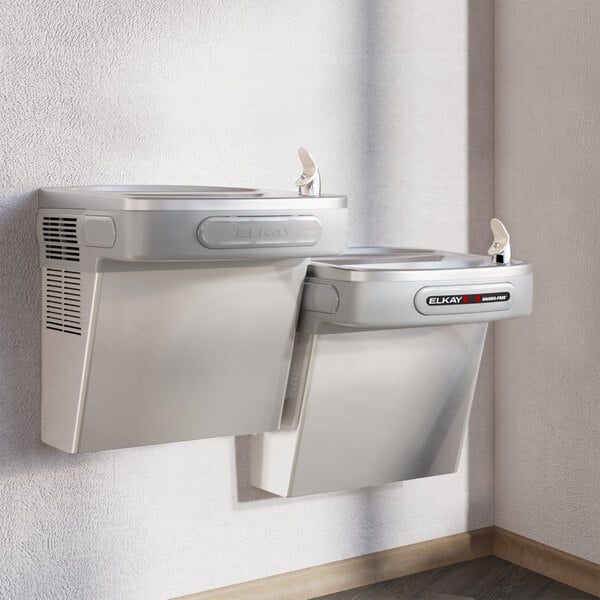 Elkay stainless steel bi-level wall mount chilled drinking fountain with two water dispensers.