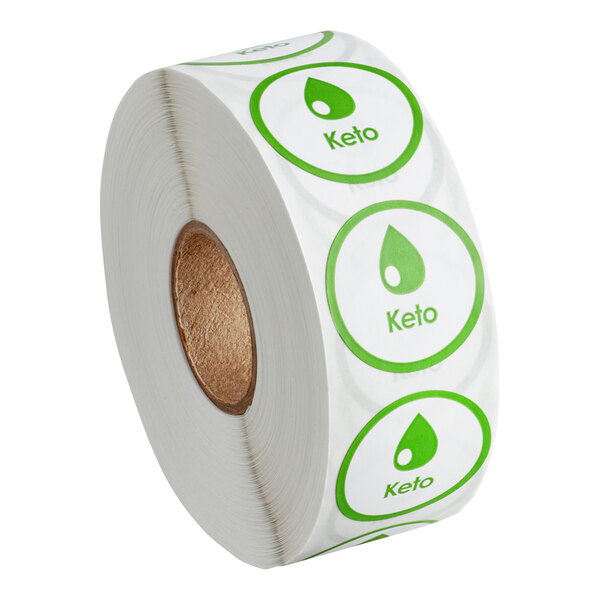 A roll of white paper with green circles on it that are keto labels.