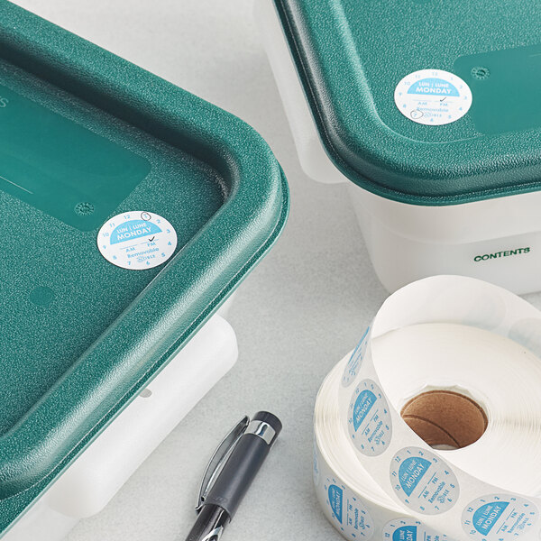 A green plastic container of Noble Products Monday Day of the Week labels on a table.