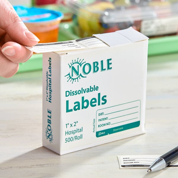 A box of Noble 1" x 2" dissolvable hospital labels containing 500 labels per roll.