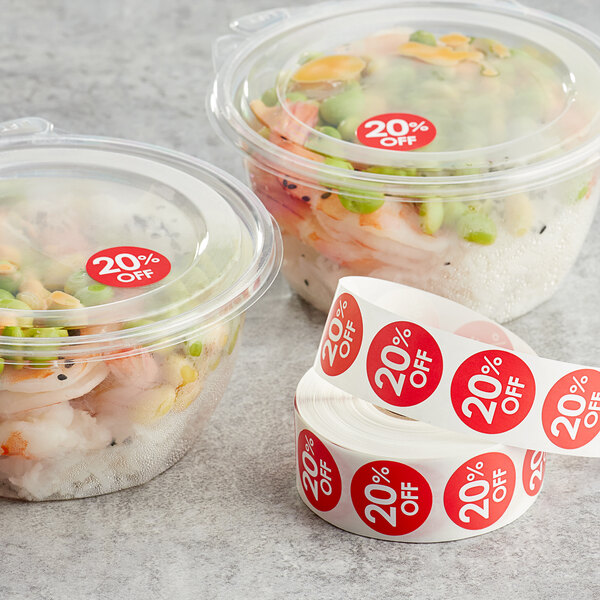 A plastic container of food next to a roll of Point Plus red labels.