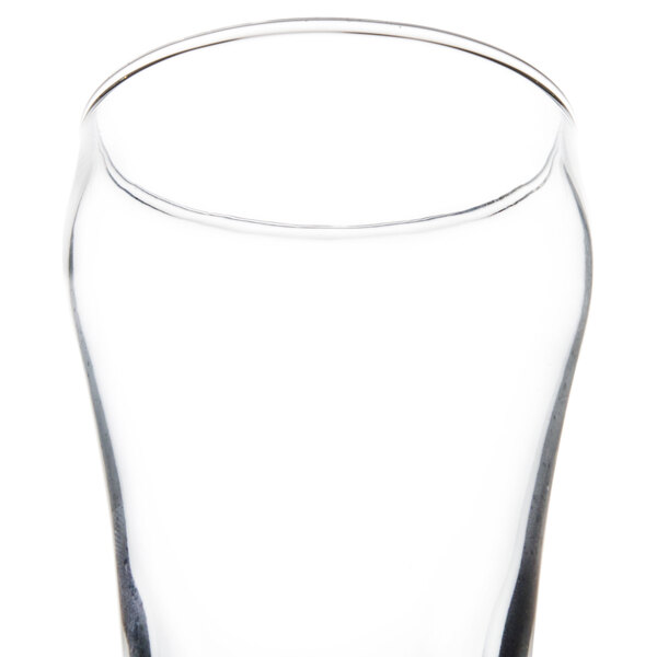 A close up of a Libbey bell fountain tumbler with a clear rim and a straw.