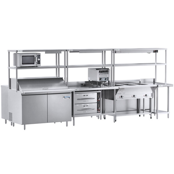 A stainless steel Chef's Counter preparation line in a large commercial kitchen.