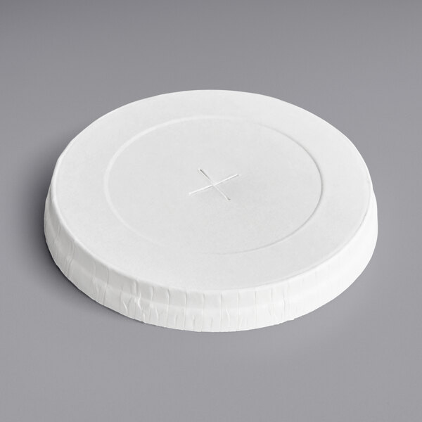 A white paper lid with a straw slot over a white circle.