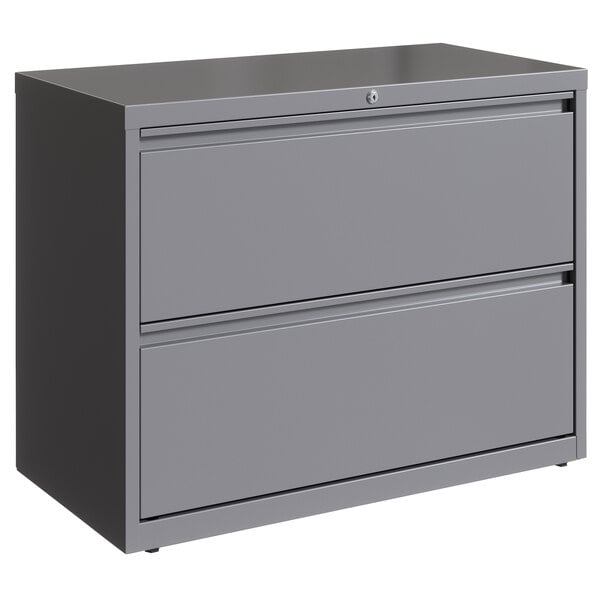 A Hirsh Industries grey metal lateral file cabinet with two drawers.