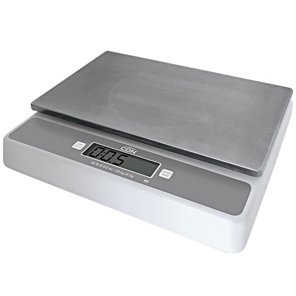 A CDN digital portion scale with a silver top and white base on a counter.