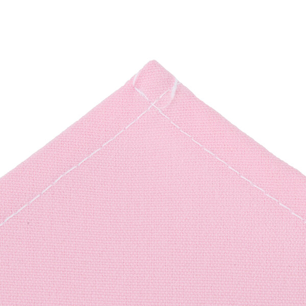 A folded light pink Intedge chef neckerchief with white stitching.