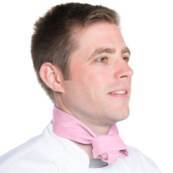 A man wearing a light pink Intedge chef neckerchief.