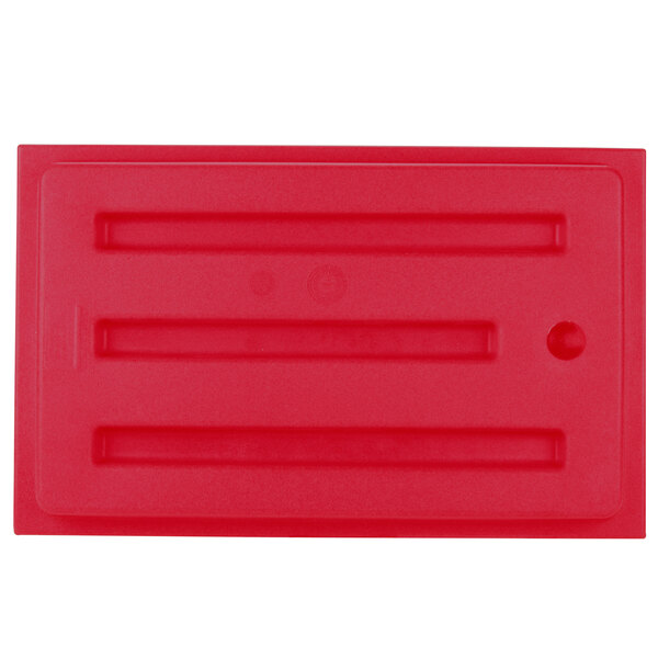 A red rectangular plastic cover with a black border and four holes.