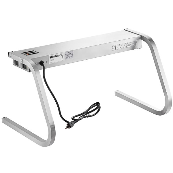 A silver rectangular ServIt strip warmer with a black cord on a table.