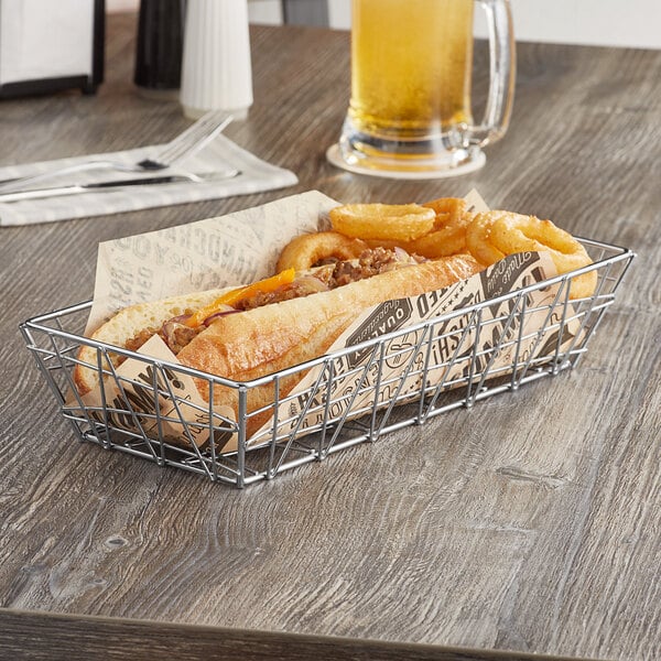 A chrome rectangular basket filled with a hot dog and onion rings.