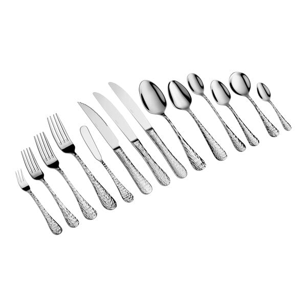 A set of various stainless steel cutlery pieces, including forks, knives, and spoons, arranged in a row on a white background.