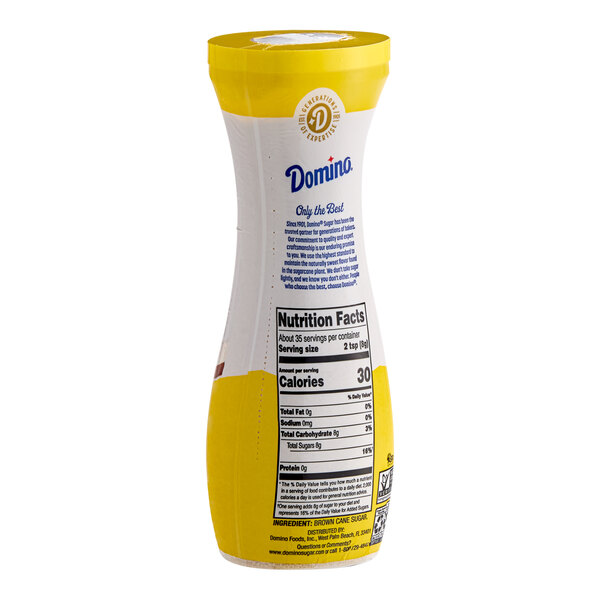 A yellow and white Domino pourable flip-top canister of brown sugar with a label.