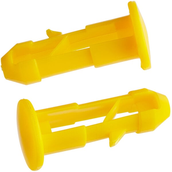 Two yellow plastic dowels.